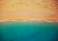 Aerial shot of a beach with blue water