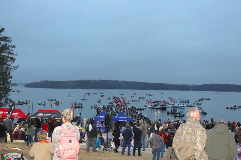 Spectators await the Bassmaster Classic takeoff from land and the water.